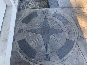 Stamped concrete compass medallion