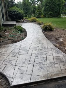 Rochester home showing a new stamped concrete walkway