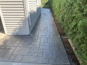 Stamped concrete walkway extending to a matching patio