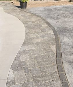 Patio pavers edging around an inground swimming pool