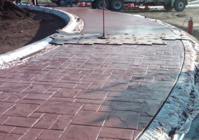 Concrete being stamped to create a pattern