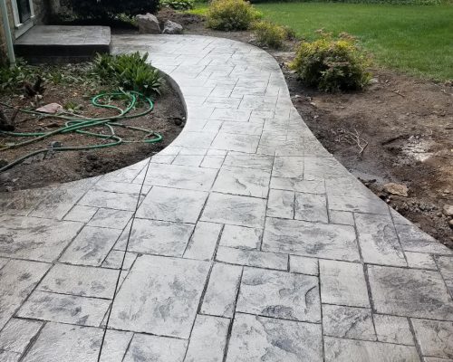 Rochester home showing a new stamped concrete walkway